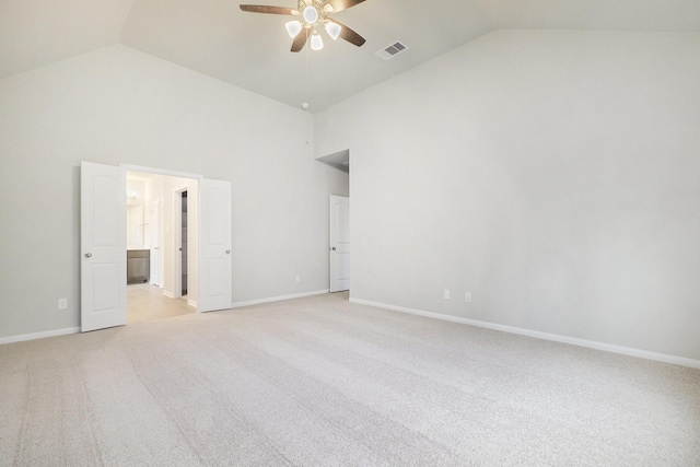 carpeted spare room with high vaulted ceiling and ceiling fan