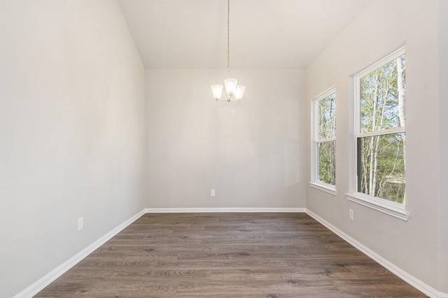 unfurnished dining area featuring dark hardwood / wood-style floors and an inviting chandelier