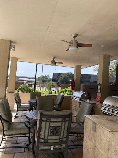 view of patio / terrace featuring an outdoor kitchen, ceiling fan, and grilling area