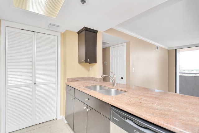 kitchen with light tile patterned floors, stainless steel dishwasher, crown molding, and sink