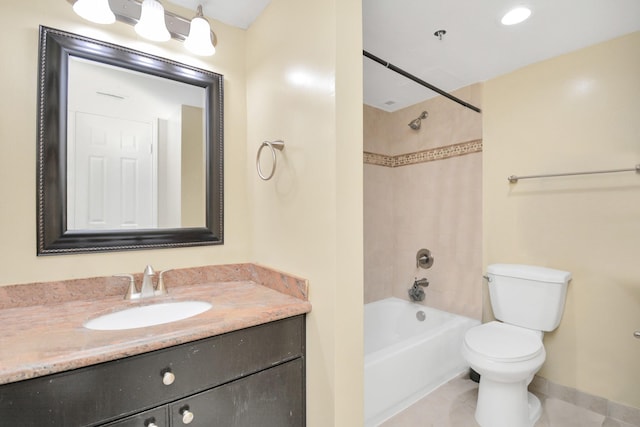 full bathroom featuring vanity, tiled shower / bath combo, toilet, and tile patterned flooring