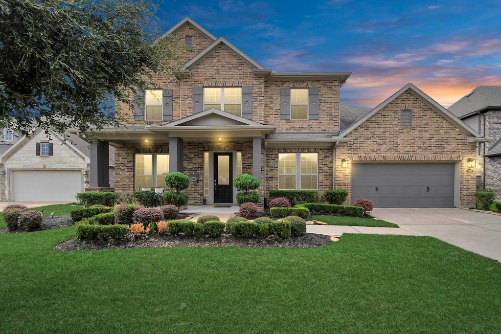 craftsman-style home with a yard and a garage