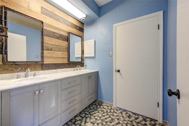 bathroom featuring wooden walls and vanity