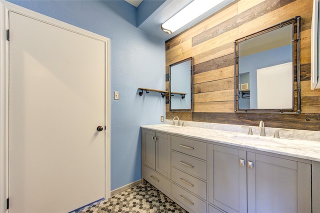 bathroom with vanity and wood walls