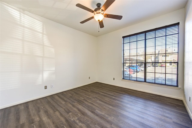 spare room featuring ceiling fan and dark wood-type flooring