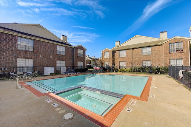 view of swimming pool featuring a community hot tub and a patio