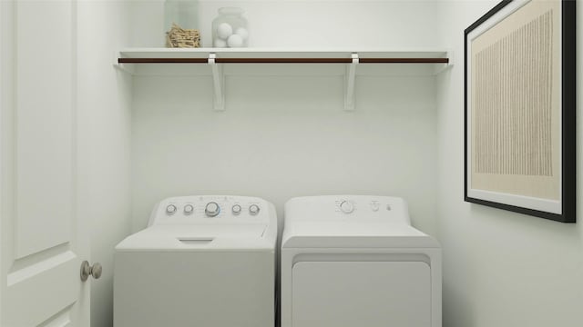 clothes washing area with washer and clothes dryer