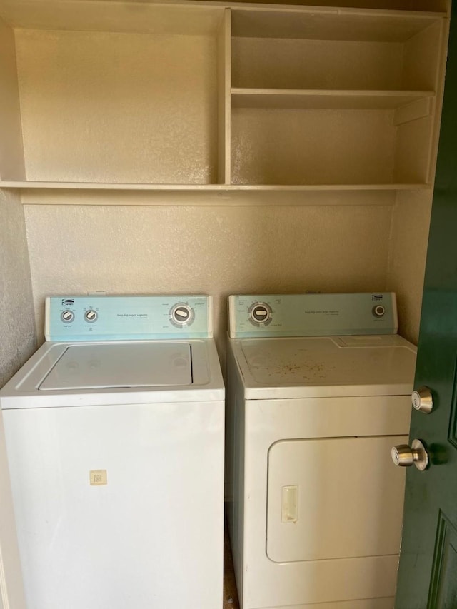 clothes washing area with washing machine and dryer