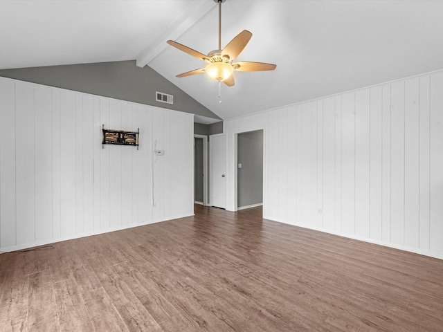 spare room featuring lofted ceiling with beams, ceiling fan, and dark wood-type flooring