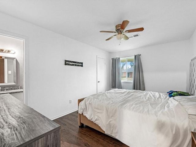 bedroom featuring ensuite bath, ceiling fan, and dark wood-type flooring