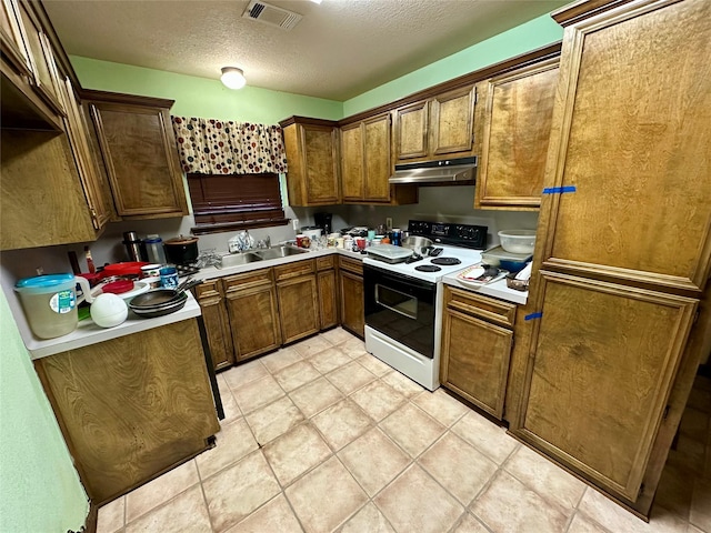 kitchen with electric range, sink, and a textured ceiling