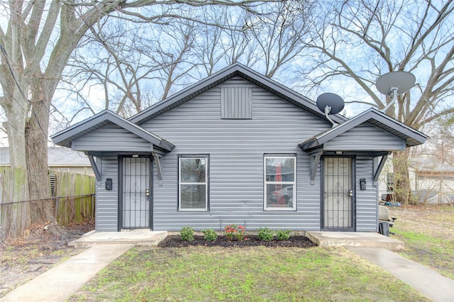 bungalow-style house with a front lawn