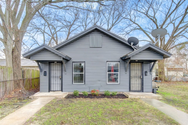 bungalow-style house with a front yard