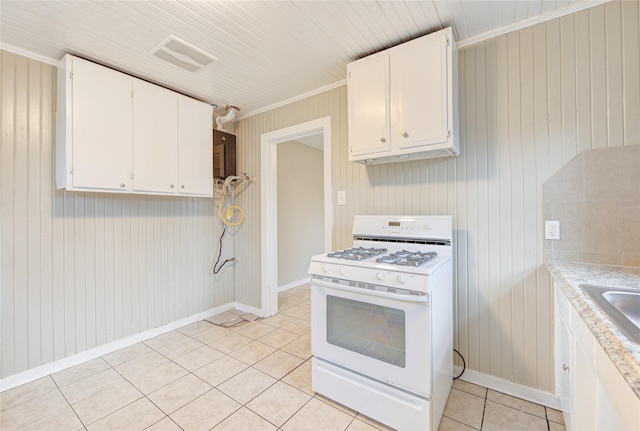 kitchen with white cabinets, crown molding, white gas stove, and light tile patterned flooring