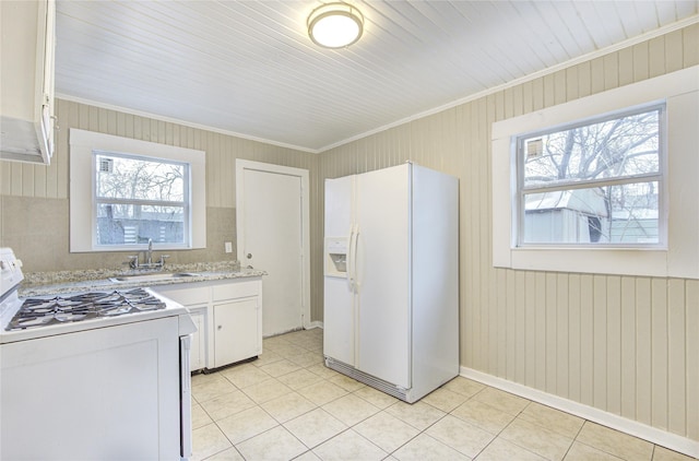 kitchen featuring light stone countertops, white appliances, crown molding, sink, and white cabinets