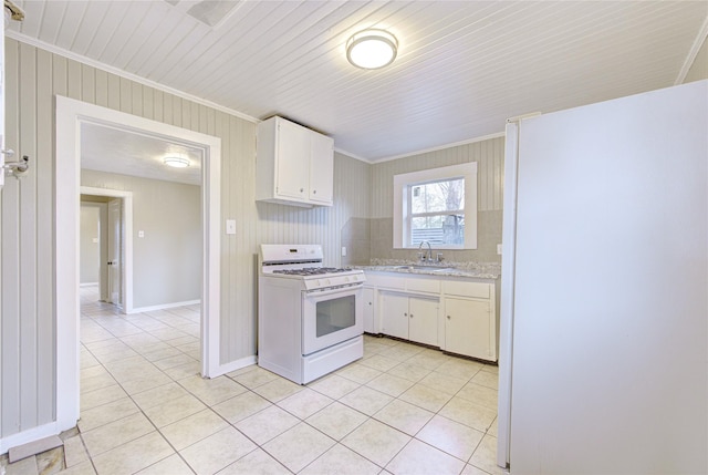 kitchen with white appliances, crown molding, sink, white cabinets, and light tile patterned flooring