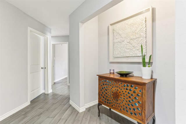 hallway with light hardwood / wood-style flooring