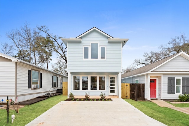 view of front property featuring a front lawn and cooling unit