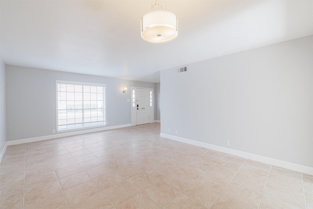 empty room with light tile patterned flooring