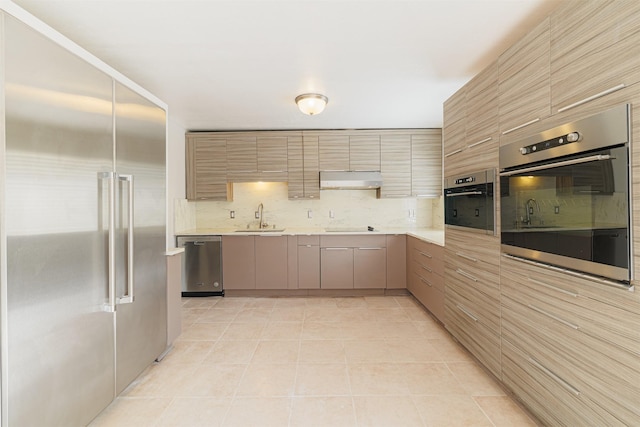 kitchen featuring light tile patterned floors, backsplash, stainless steel appliances, and sink