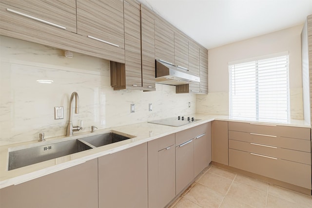 kitchen featuring backsplash, sink, light tile patterned floors, and black electric stovetop