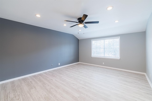 spare room featuring ceiling fan, light hardwood / wood-style flooring, and lofted ceiling