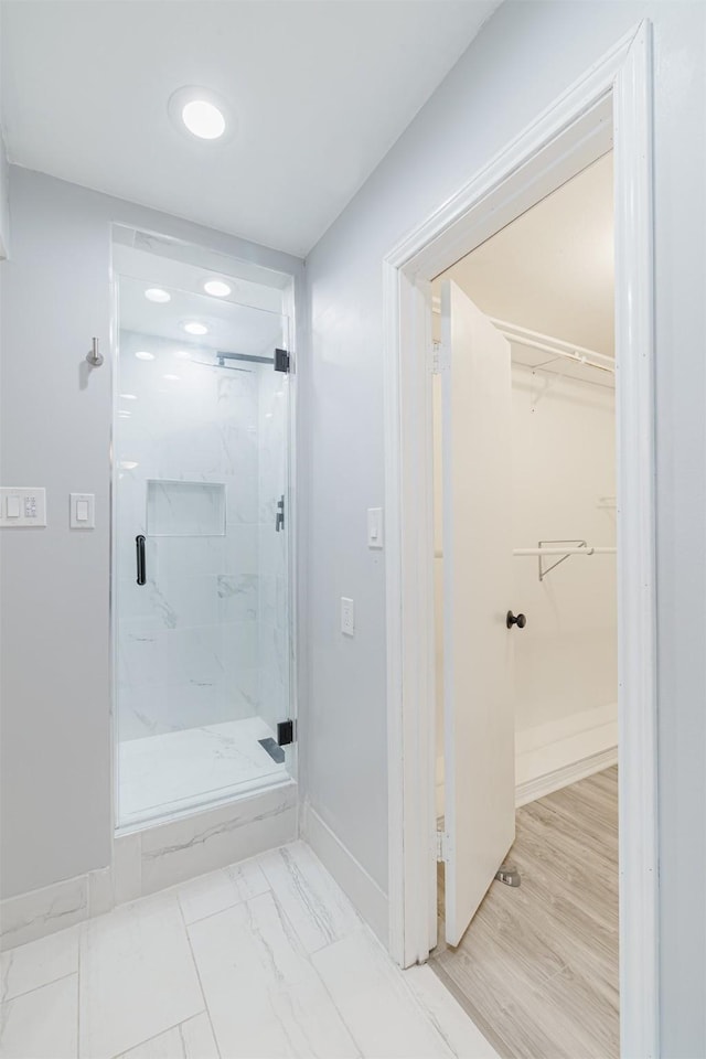 bathroom featuring a shower with shower door