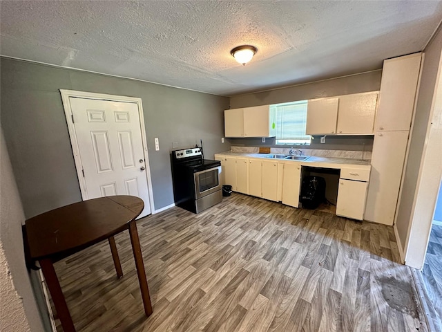 kitchen featuring light wood-type flooring, a textured ceiling, sink, white cabinets, and stainless steel electric range oven