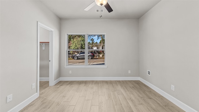 unfurnished room with ceiling fan and light hardwood / wood-style floors