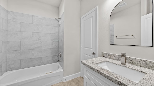 bathroom with vanity and tiled shower / bath combo