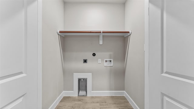 laundry room featuring hookup for a gas dryer, light hardwood / wood-style flooring, washer hookup, and hookup for an electric dryer