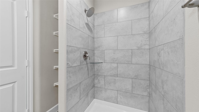 bathroom with tiled shower