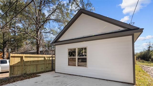 view of side of property with a patio