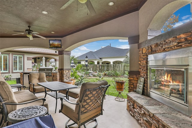 view of patio / terrace featuring outdoor lounge area, an outdoor kitchen, area for grilling, and ceiling fan