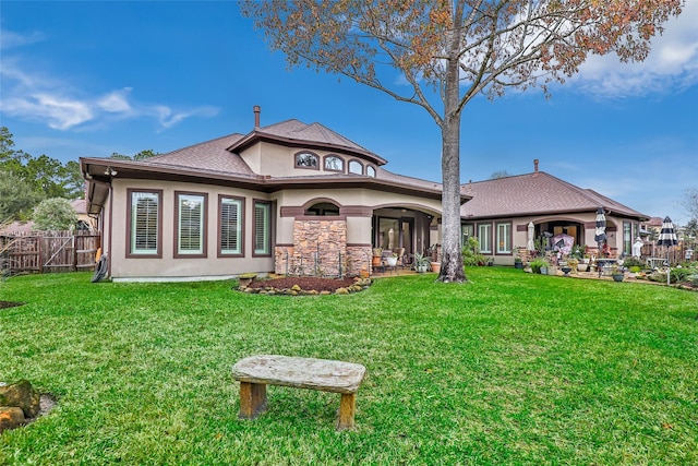 rear view of house with a lawn