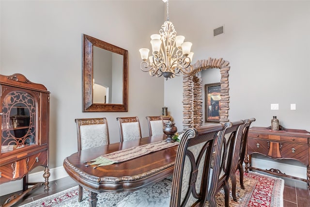 dining room featuring hardwood / wood-style floors and a chandelier