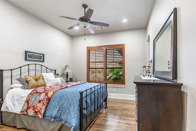 bedroom featuring hardwood / wood-style floors and ceiling fan