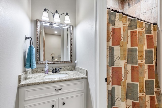 bathroom with a shower with curtain and vanity