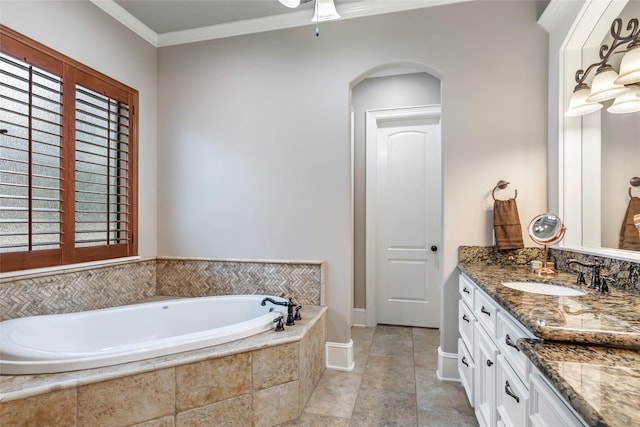 bathroom with vanity, ornamental molding, and tiled bath