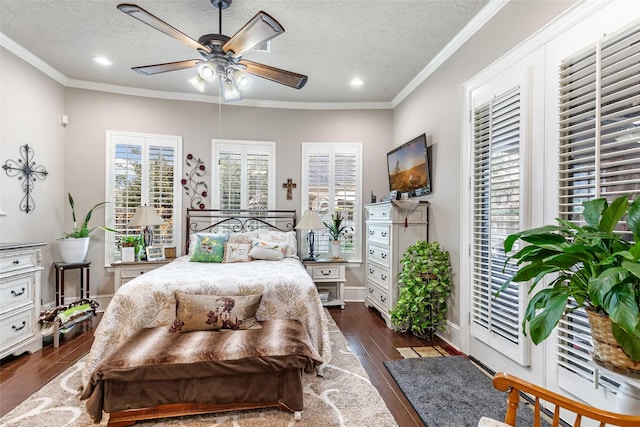 bedroom featuring ceiling fan, crown molding, a textured ceiling, and dark wood-type flooring