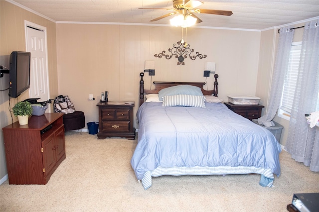 carpeted bedroom with ceiling fan and ornamental molding