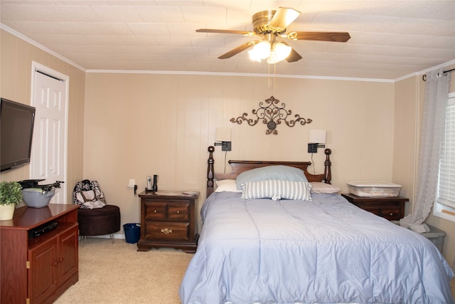 carpeted bedroom featuring ceiling fan and ornamental molding