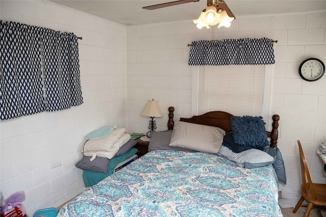 bedroom with ornamental molding and ceiling fan