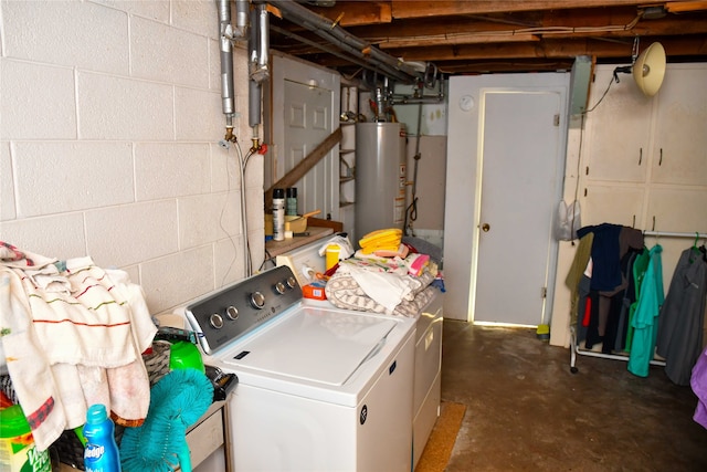 laundry area with gas water heater and washer and dryer