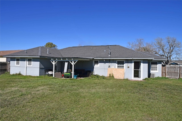 rear view of property featuring a yard and a patio area