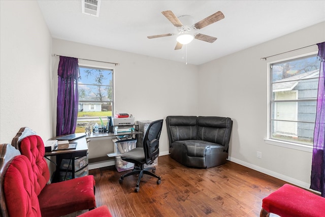 home office featuring a wealth of natural light, dark wood-type flooring, and ceiling fan