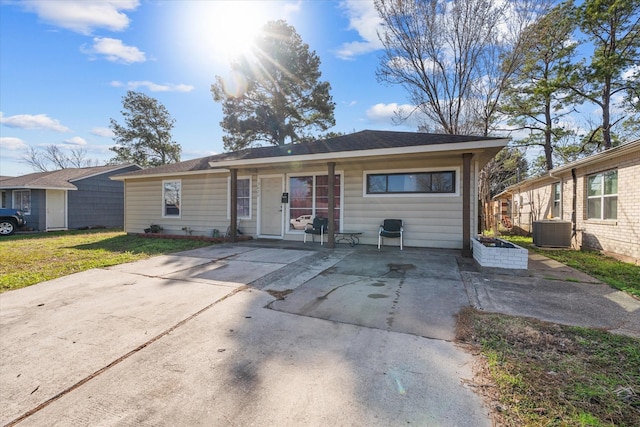 ranch-style house with a front yard and cooling unit