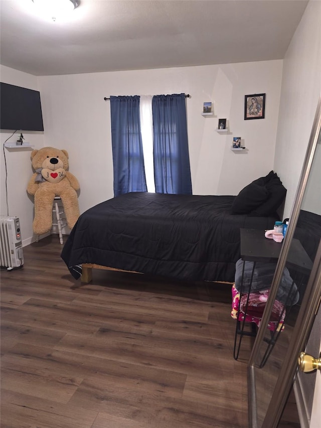 bedroom with dark wood-type flooring