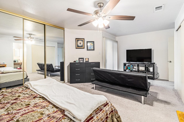 carpeted bedroom with a closet and ceiling fan