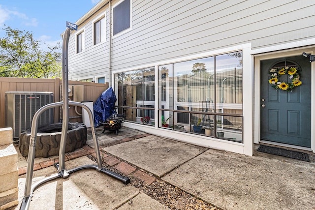 view of patio with cooling unit and an outdoor fire pit